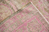 Distressed vintage Sivas rug, showing worn fuchsia pink pile, knot heads, and woven foundation.
