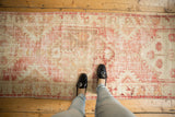 Pale dusty raspberry and antique ivory distressed Oushak rug runner.