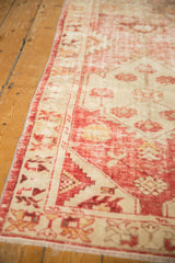 Distressed vintage Oushak runner, showing its pale raspberry red and antique ivory field wear.