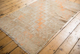 Distressed hand knotted vintage Oushak rug with tangerine geometric hook and latch motifs.