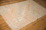 Distressed vintage Oushak rug corner, even wear, secure edge, tangerine hook and latch pattern.