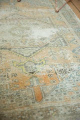 Worn pile texture of distressed Oushak rug in faded pale orange and oxidized silver.