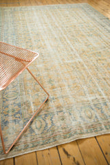 Softened textures and pale gold, blue vinery motifs on a vintage distressed Oushak rug.