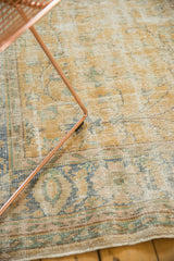 Distressed vintage Oushak rug featuring mostly even wear, gold, blue, and ivory vinery.