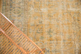 Decorative distressed Oushak rug pile with pale gold, beige, and softened blue vinery.