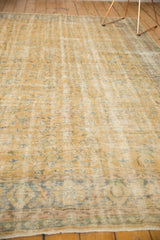 Distressed Oushak rug border with worn pile, pale gold, blue vinery, and intact selvage.