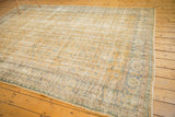 Distressed vintage Oushak carpet featuring faded allover vinery in gold and denim blue.
