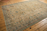 Distressed pattern and intact side cord selvage of the vintage Oushak rug, showing mint green and sand tones.