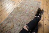 Distressed vintage Oushak runner with faded geometric patterns and worn pile texture.