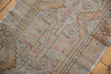 Distressed Oushak runner showcasing textural wear, geometric forms, and bubblegum pink accents.