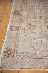 Distressed Oushak runner edge, geometric patterns, pale terracotta, pink, faint foundation.