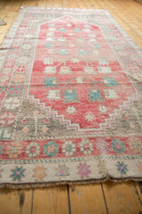Muted fringe and geometric border patterns on this vintage Oushak runner.