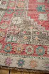 Distressed vintage Oushak runner with even wear, muted geometric motifs, and soft colors.