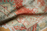 Distressed rust red, seafoam, and ivory pile texture of the vintage Oushak rug.