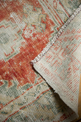 Distressed pile texture of vintage Oushak rug in rust red, seafoam green, showing secured side and foundation.