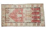 Vintage distressed Oushak runner with faded cherry red, ivory, tangerine plant motifs and geometric border.