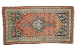 Antique Malayer hand-knotted rug, madder red field, navy medallion, germinating shrubs.