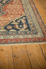 Antique Malayer rug's geometric borders and germinating shrub field with rich abrash.