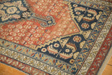 Antique Malayer rug detail: navy blue borders, dusty rust field, germinating shrubs, even wear.