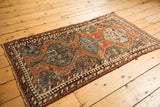 Corner detail of vintage Kamseh rug showing slate blue field, madder root rust, and reciprocating pawn motif.
