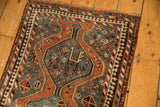 Vintage Kamseh rug's slate blue field, reciprocating pawn border, and various geometric motifs.