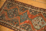 Slate blue medallion and rust field with playful motifs and pawn border on a Kamseh rug.