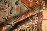 Folded vintage Kamseh rug with unique reciprocating pawn motif border, slate blue, madder root rust.