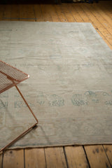 Faded sea foam green patterns on distressed low pile vintage Oushak rug.