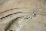 Distressed vintage Oushak carpet with low pile texture, in faded beige and sea foam green.