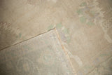 Distressed low pile and secured hand-knotted reverse of a vintage Oushak carpet.