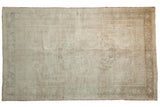 Faded vintage distressed Oushak rug with medallion and vine patterns in pale coffee and ivory.