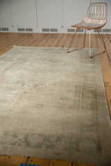Muted silver, pale coffee brown distressed Oushak border with low pile texture.