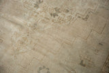 Vintage distressed Oushak carpet close-up, highlighting low pile texture, stepped motifs, and muted coffee tones.