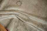 Detail of the vintage distressed Oushak carpet's low, even pile texture in muted tones.