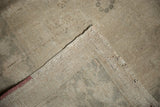 Distressed vintage Oushak rug showing low pile texture and tightly woven reverse.