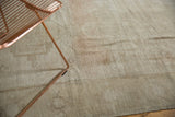Heavily abrashed ivory, sand, blush field on distressed vintage Oushak carpet.