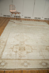 Low pile abrashed ivory field and coffee brown geometric patterns on vintage Oushak rug.