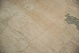 Distressed vintage Oushak carpet showing low pile texture and faded forest green teal pattern.