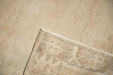 Distressed Oushak rug corner showing low pile, secured edge, and detailed woven reverse.