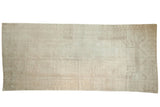 Distressed Oushak runner with a subtle medallion, low pile, and neutral ivory, silver tones, 5' x 11'4