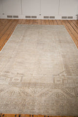 Subtle geometric border and field motifs on a distressed vintage Oushak runner with low pile.