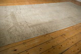 Vintage distressed Oushak rug runner border with faded ivory and platinum geometric motifs.