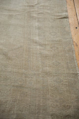 Distressed low pile of vintage Oushak runner, showing ivory and oxidized silver tones.