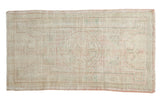 Distressed Vintage Oushak rug with faded ivory, pale blush, and mint green medallion, 2'5