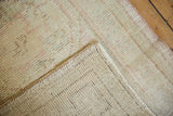 Visible even wear on the Oushak rug's ivory pile and its secured, tightly woven reverse.