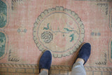 Distressed Oushak runner texture: pink field, pale green medallion, even wear showing foundation.