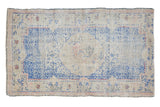 Distressed vintage Oushak rug, faded cobalt blue, antique ivory medallion, blush accents, 2'10