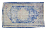 Distressed Oushak rug with faded cobalt blue, ivory roundel, and subtle rose motifs, 2'8