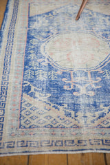 Distressed pile with visible foundation on vintage Turkish Oushak rug, cobalt blue and blush patterns.