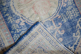 Distressed Vintage Oushak rug showing worn cobalt blue pile and hand-knotted foundation.